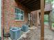 Brick townhouse backyard with dual Carrier AC units and access door at 5430 Dockery Dr, Charlotte, NC 28209