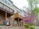 Backyard view showcasing multiple decks and a flowering tree, perfect for outdoor enjoyment at 5430 Dockery Dr, Charlotte, NC 28209