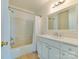 Bright bathroom featuring a shower and tub combination with a single sink vanity and neutral tile flooring at 5430 Dockery Dr, Charlotte, NC 28209