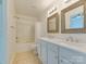This bathroom is equipped with a dual sink vanity, framed mirrors, and a shower-tub combo at 5430 Dockery Dr, Charlotte, NC 28209