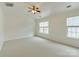 Large bedroom with neutral carpet, a ceiling fan, and natural light streaming in through the windows at 5430 Dockery Dr, Charlotte, NC 28209