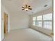 This carpeted bedroom is full of natural light and equipped with a ceiling fan at 5430 Dockery Dr, Charlotte, NC 28209