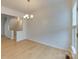 Spacious dining area with hardwood floors, a chandelier, and natural light from a nearby window at 5430 Dockery Dr, Charlotte, NC 28209