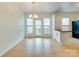 Bright dining area with hardwood floors, classic chandelier, and access to the outdoor space at 5430 Dockery Dr, Charlotte, NC 28209