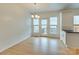 Bright dining area featuring hardwood floors, a chandelier, and a door leading to the outside at 5430 Dockery Dr, Charlotte, NC 28209