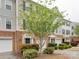 Exterior view of townhomes with brick and siding facades, garages, and landscaping at 5430 Dockery Dr, Charlotte, NC 28209
