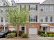 Townhome exterior featuring brick and siding facade, garage, and manicured landscaping at 5430 Dockery Dr, Charlotte, NC 28209