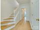 Bright foyer with hardwood floors, white trim and stairs leading to upper level at 5430 Dockery Dr, Charlotte, NC 28209