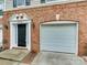 Townhome exterior showing the front door, garage and brick facade at 5430 Dockery Dr, Charlotte, NC 28209