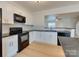 Bright kitchen features white cabinets, black appliances, and an open design, perfect for modern living at 5430 Dockery Dr, Charlotte, NC 28209