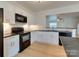 Bright kitchen features white cabinets, black appliances, and an open design, perfect for modern living at 5430 Dockery Dr, Charlotte, NC 28209