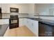 Modern kitchen featuring black countertops, and updated appliances for a stylish cooking space at 5430 Dockery Dr, Charlotte, NC 28209