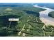 Breathtaking aerial view of the property surrounded by lush greenery and stunning lakeside views at 676 Chapel Hill Dr, Troy, NC 27371