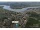 Aerial shot shows the property near a beautiful lake and lush forests located at 676 Chapel Hill Dr, Troy, NC at 676 Chapel Hill Dr, Troy, NC 27371