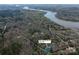Aerial view of 676 Chapel Hill Dr, Troy, NC, property surrounded by trees, with lake view at 676 Chapel Hill Dr, Troy, NC 27371
