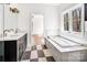 Bathroom featuring dual sinks, soaking tub, and window with view of the outdoors at 676 Chapel Hill Dr, Troy, NC 27371