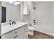 Well-lit bathroom featuring stylish vanity and sink, bathtub, and shower at 676 Chapel Hill Dr, Troy, NC 27371