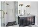 Contemporary bathroom with a glass-enclosed shower, dual sinks, and modern fixtures at 676 Chapel Hill Dr, Troy, NC 27371