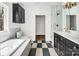 Bright bathroom with soaking tub, tiled floors, and modern vanity with gold fixtures at 676 Chapel Hill Dr, Troy, NC 27371