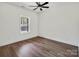 Cozy bedroom with wood-look floors, and a large window for natural light at 676 Chapel Hill Dr, Troy, NC 27371