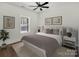 Cozy bedroom with neutral tones, soft lighting, and a large window overlooking trees at 676 Chapel Hill Dr, Troy, NC 27371