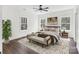 Bright bedroom boasts hardwood floors, a ceiling fan, and a large window with scenic views at 676 Chapel Hill Dr, Troy, NC 27371
