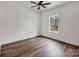 Bright bedroom featuring wood-look flooring and a large window overlooking the backyard at 676 Chapel Hill Dr, Troy, NC 27371