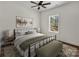 Comfortable bedroom featuring a large bed, ceiling fan and a window with a view at 676 Chapel Hill Dr, Troy, NC 27371