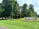 Welcome to Carolina Forest, where flags and trees create a beautiful entrance at 676 Chapel Hill Dr, Troy, NC 27371