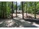 Scenic driveway leading to a secluded home surrounded by towering trees at 676 Chapel Hill Dr, Troy, NC 27371