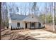 Charming exterior featuring a symmetrical facade, covered porch with wooden pillars, and neat landscaping at 676 Chapel Hill Dr, Troy, NC 27371