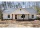 Inviting home with a covered porch supported by timber pillars, creating a cozy and welcoming entrance at 676 Chapel Hill Dr, Troy, NC 27371