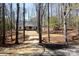 Charming white home nestled among trees, offering a private and serene setting at 676 Chapel Hill Dr, Troy, NC 27371