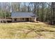 New home with a gray roof, spacious porch, and serene surroundings at 676 Chapel Hill Dr, Troy, NC 27371