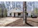 Beautifully designed white home with striking dark-framed windows and a welcoming porch at 676 Chapel Hill Dr, Troy, NC 27371