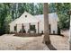Beautiful home with a welcoming front porch and rocking chairs, nestled in a wooded setting at 676 Chapel Hill Dr, Troy, NC 27371