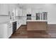 Modern kitchen with stainless steel appliances, an island, and bright white cabinets at 676 Chapel Hill Dr, Troy, NC 27371