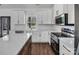 Elegant kitchen featuring white cabinets, marble countertops, stainless steel appliances, and a center island at 676 Chapel Hill Dr, Troy, NC 27371