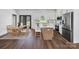 Bright kitchen boasts stainless steel appliances, a center island with seating, and hardwood floors at 676 Chapel Hill Dr, Troy, NC 27371