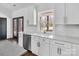 Modern kitchen showcasing white cabinetry, marble countertops, stainless steel appliances, and natural light at 676 Chapel Hill Dr, Troy, NC 27371