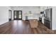 Open-concept kitchen with stainless steel appliances, an island, and view to backyard through french doors at 676 Chapel Hill Dr, Troy, NC 27371