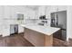 Bright kitchen featuring white cabinets, stainless steel appliances, and an island with a marble countertop at 676 Chapel Hill Dr, Troy, NC 27371