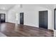 Bright living room features sleek hardwood floors, neutral walls, and black paneled doors at 676 Chapel Hill Dr, Troy, NC 27371