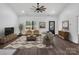 Comfortable living room features modern decor, a ceiling fan, and lots of natural light at 676 Chapel Hill Dr, Troy, NC 27371
