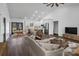 Open-concept living area with kitchen, dining, and living room under a high ceiling at 676 Chapel Hill Dr, Troy, NC 27371