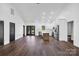 Open-concept living room with high ceilings and kitchen with stainless steel appliances at 676 Chapel Hill Dr, Troy, NC 27371
