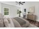 Spacious main bedroom with hardwood floors, natural light, and an ensuite bathroom at 676 Chapel Hill Dr, Troy, NC 27371