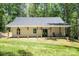 Charming rear view with a cozy porch, perfect for enjoying the tranquil surroundings at 676 Chapel Hill Dr, Troy, NC 27371