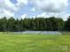 Outdoor tennis and basketball courts with chain link fence, surrounded by greenery at 676 Chapel Hill Dr, Troy, NC 27371