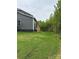 A lush green backyard featuring newly planted grass and a view of the home's screened-in porch at 7001 New Town Rd, Waxhaw, NC 28173